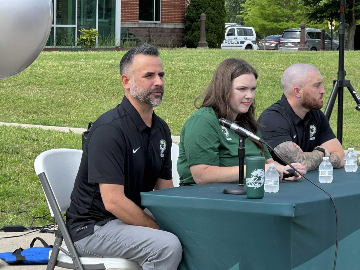 From left, Nick Marquez, Brooke Brewer and Dean Johnson listen to a question from the audience at a May 19 news conference announcing the new coaches—Marquez (women's soccer) and Johnson (men's soccer).