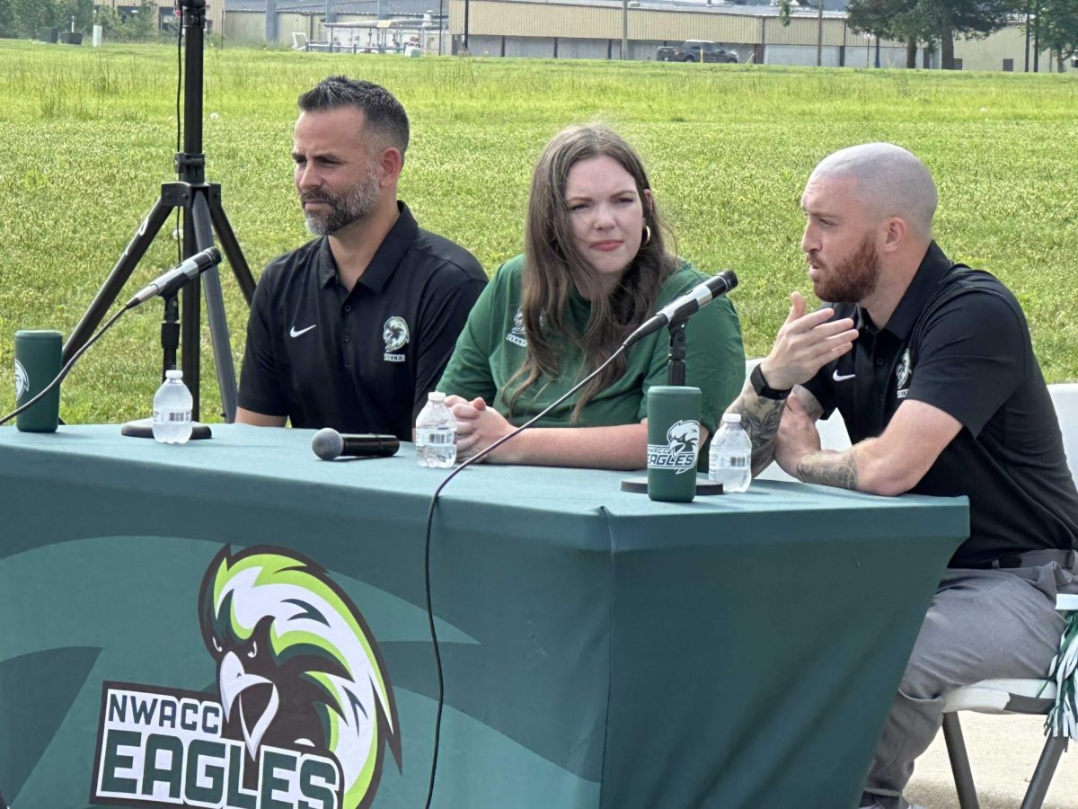 Dean Johnson (right), new men's soccer coach, talks at the May 19 news conference as Nick Marquez, new women's soccer coach, and Brooke Brewer, athletic director, listen.