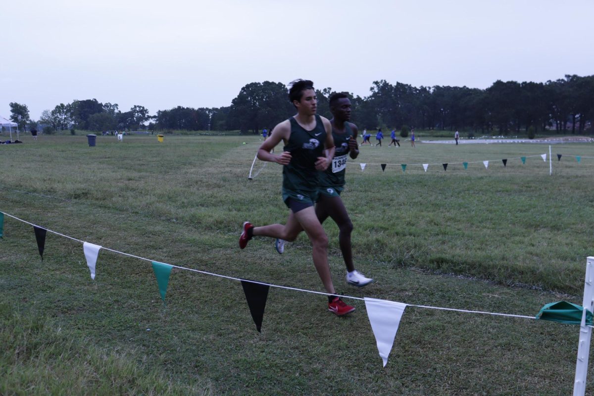 Two runners race to the finish in Friday's cross country event.