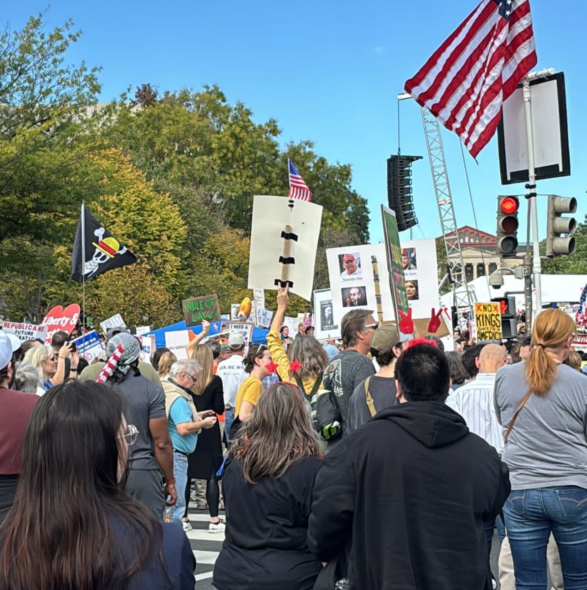 Protesters holding up various signs at the "No Kings" Rally in Washington D.C. on Oct. 18. 