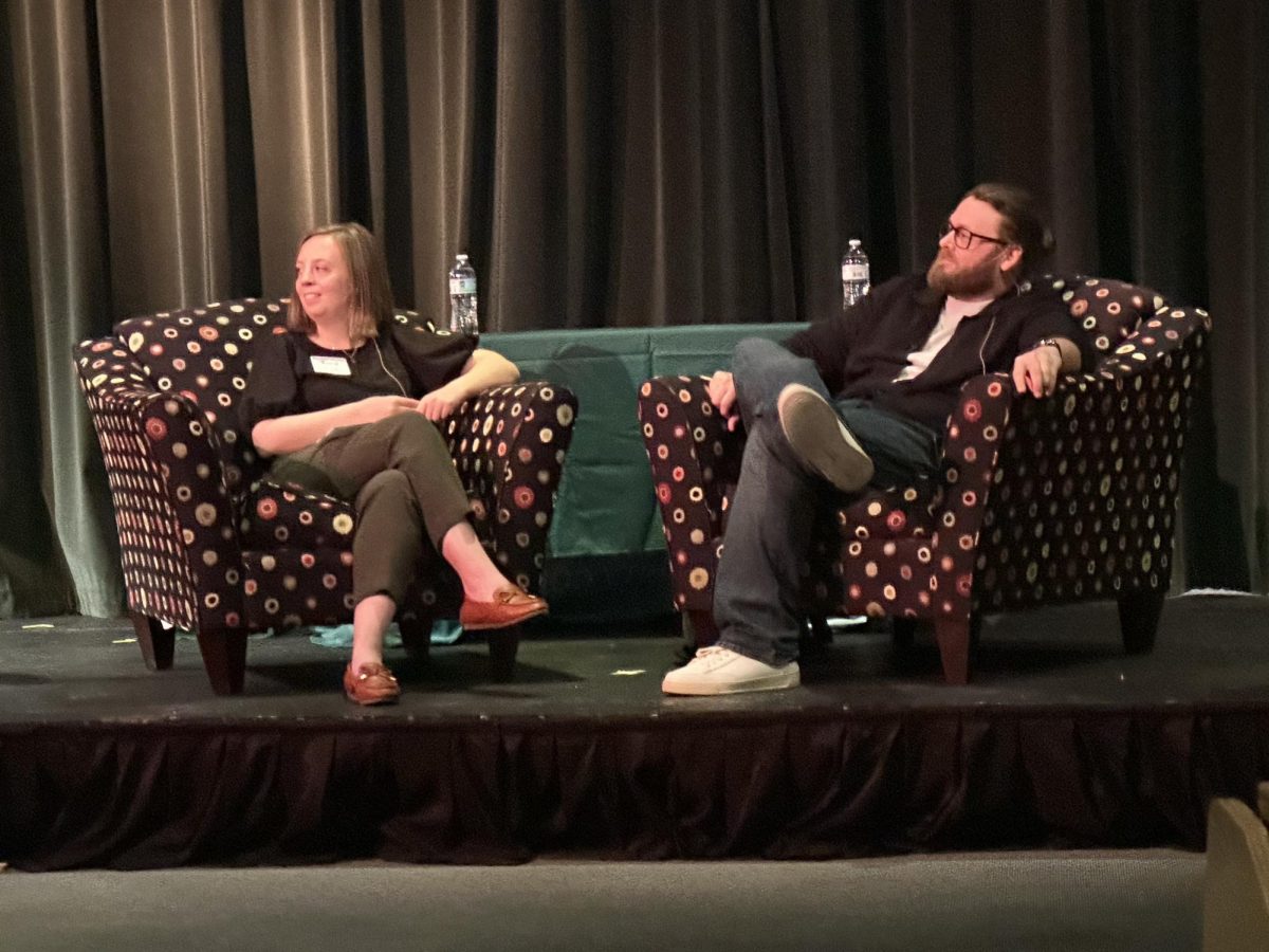 Author T.L. Simpson, right, and a representative of the Bentonville Public Library listen to a question from the audience at the end of Simpson's keynote address during the Spring Arts & Culture Festival. The Bentonville Public Library was a sponsor and collaborator for the event.