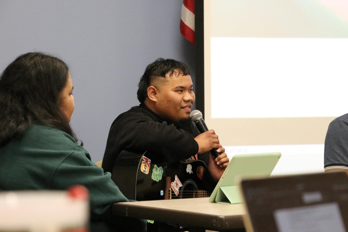 A Marshallese performer holds the microphone at a presentation related to the Marshall Islands.