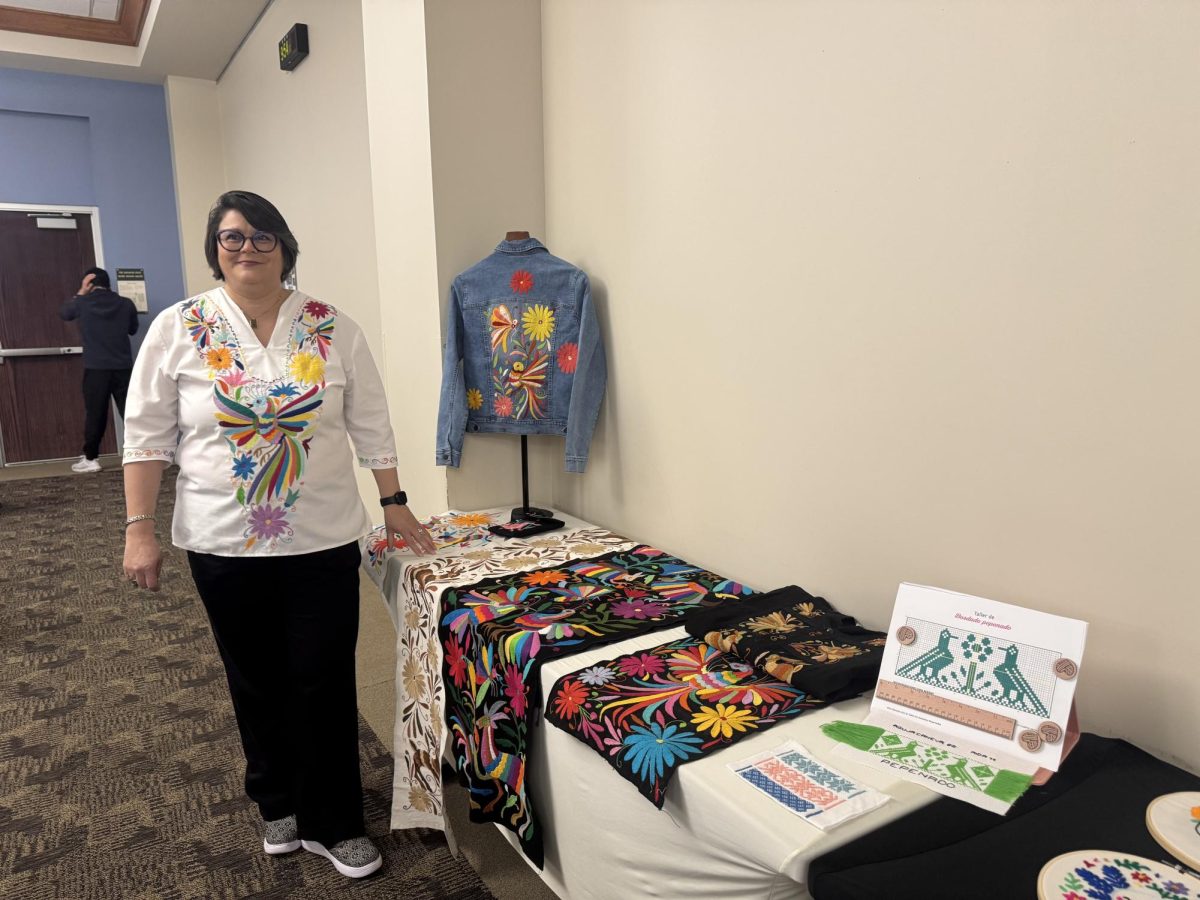 Beatriz Segura displays some of the embroidery that she said is closely tied to culture and healing.