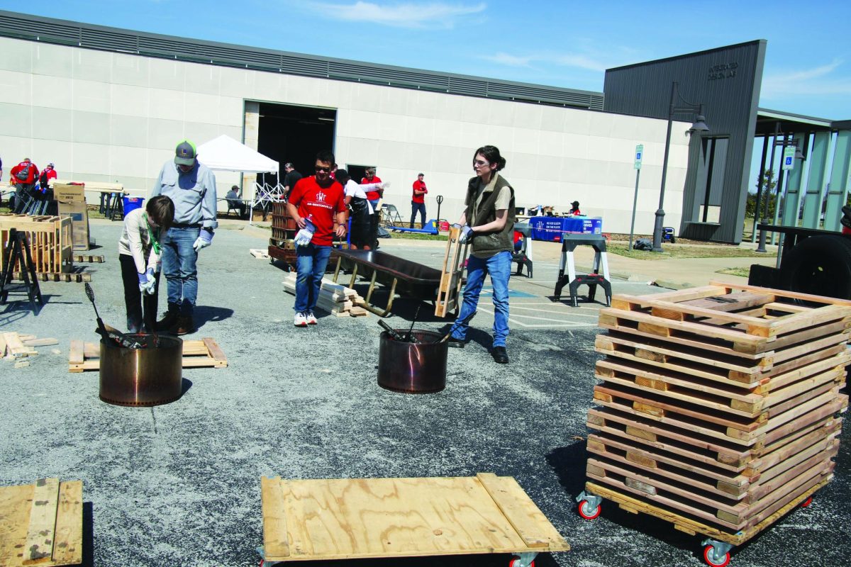 Several people are seen working outside in some of the final stages of the bed project.