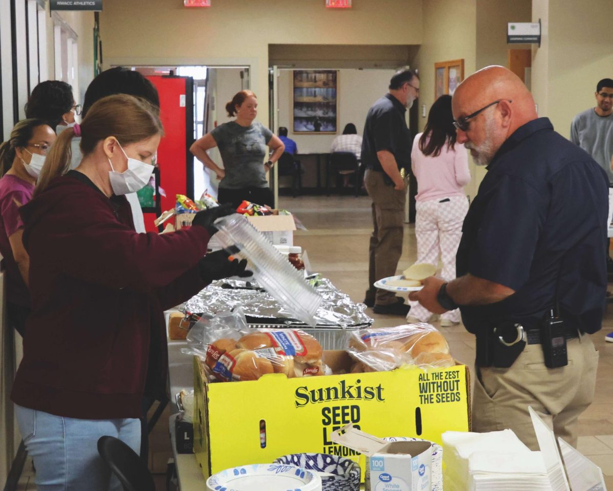A customer moves through the serving line for the barbecue fundraiser.