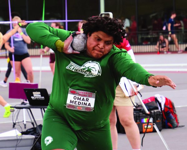 An athlete prepares to throw the shotput in an athletic invitational at the University of Arkansas.