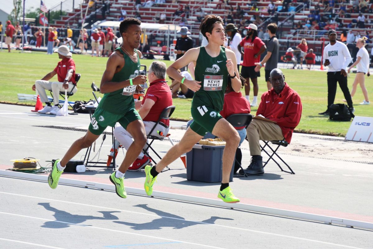 Two runners clad in the NWACC Eagles uniforms run in the 800-meter race on April 11.